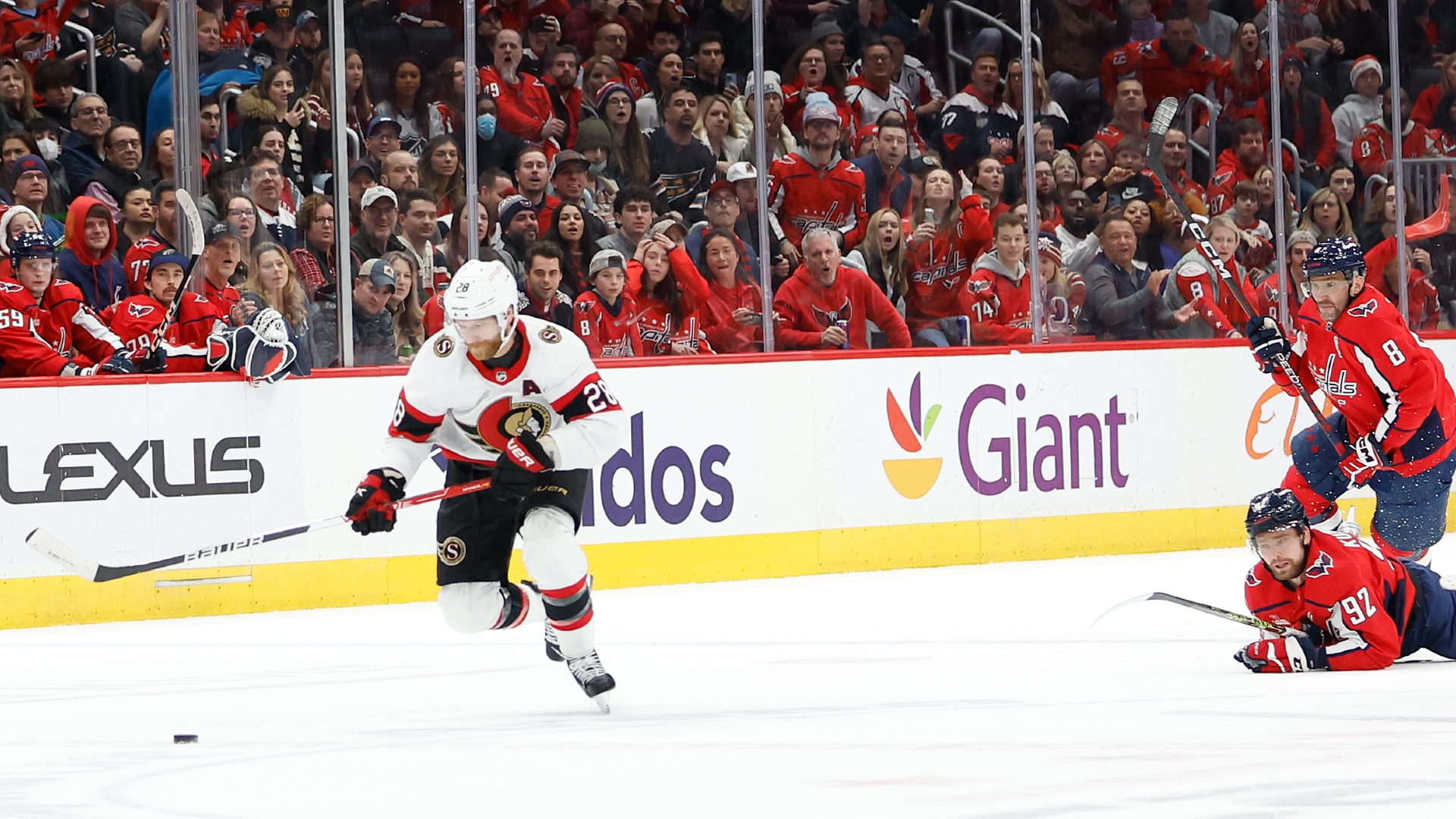 Senators right wing Claude Giroux skates with the puck past Capitals left wing Alex Ovechkin and center Evgeny Kuznetsov in overtime