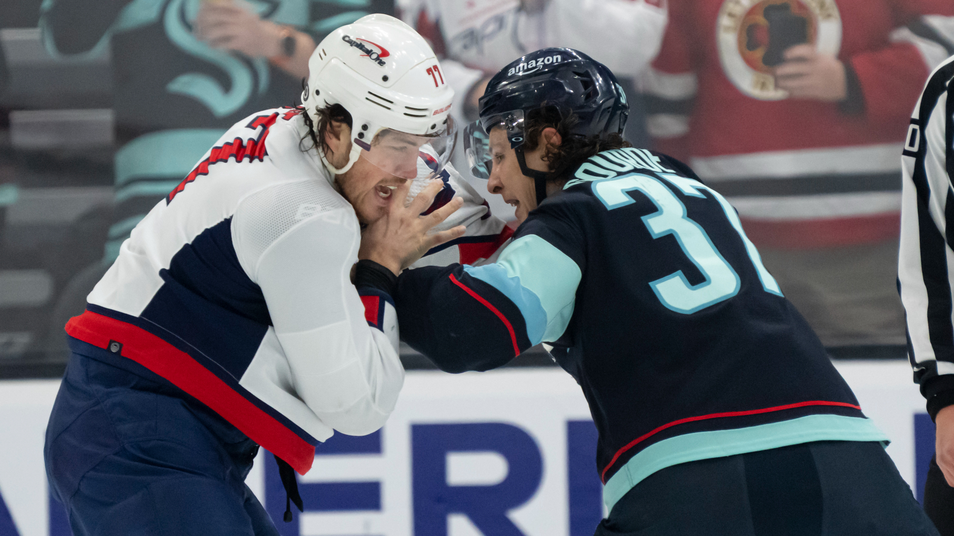 Capitals forward T.J. Oshie and Kraken forward Yanni Gourde fight during the first period at Climate Pledge Arena