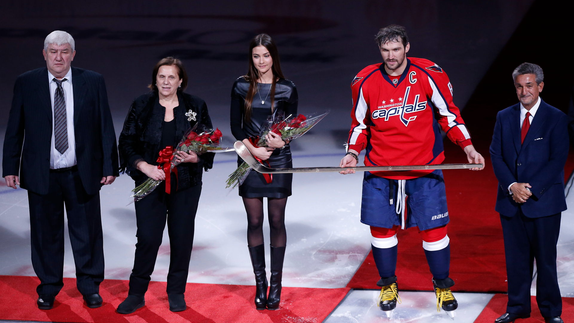 Mikhail Ovechkin, Tatyana Ovechkin, Nastya Shubskaya and Capitals left wing Alex Ovechkin stand with Ted Leonsis during a ceremony honoring Ovechkin's 500th goal
