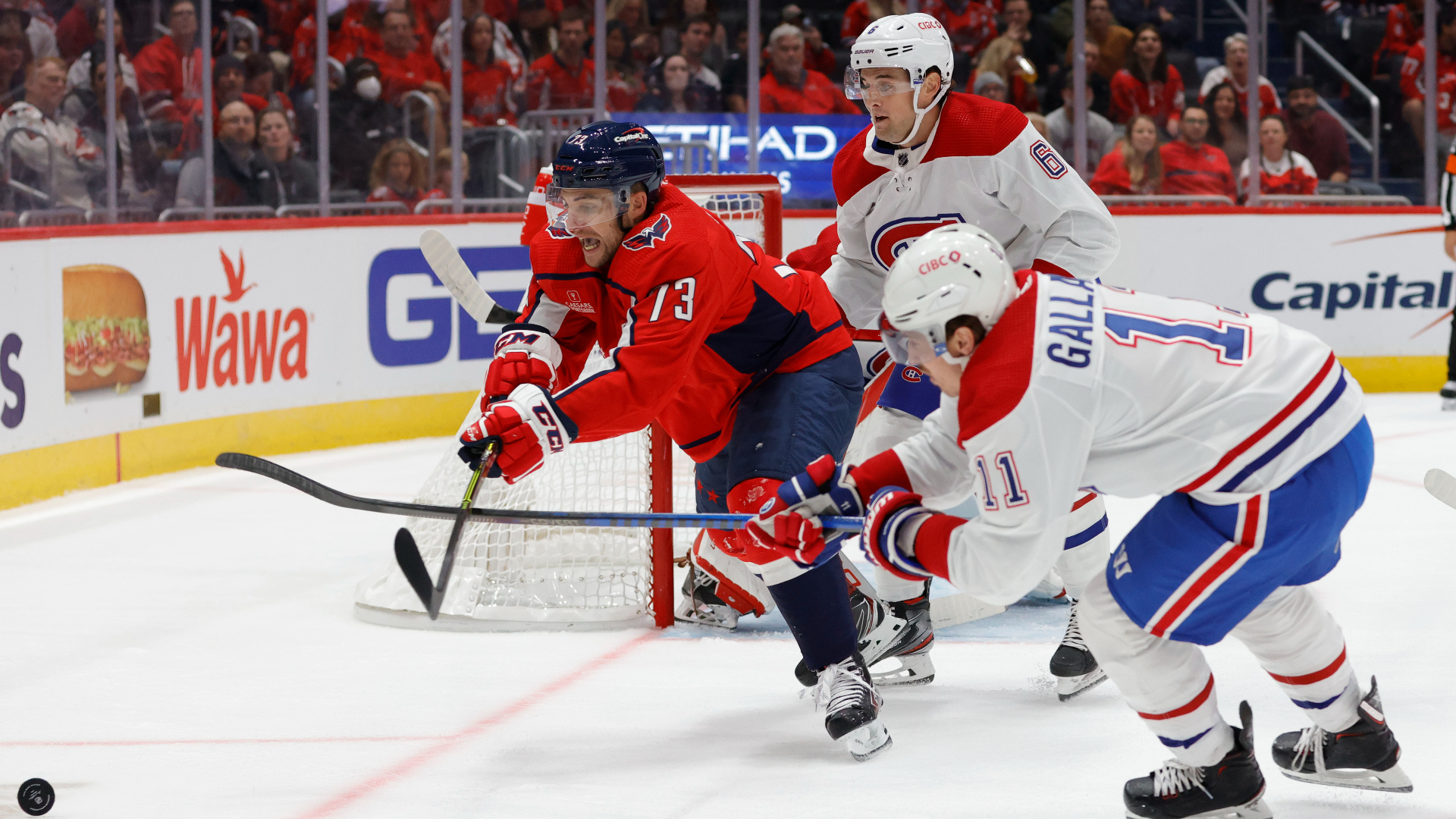 Capitals winger Conor Sheary dives for the puck in a game against the Canadiens