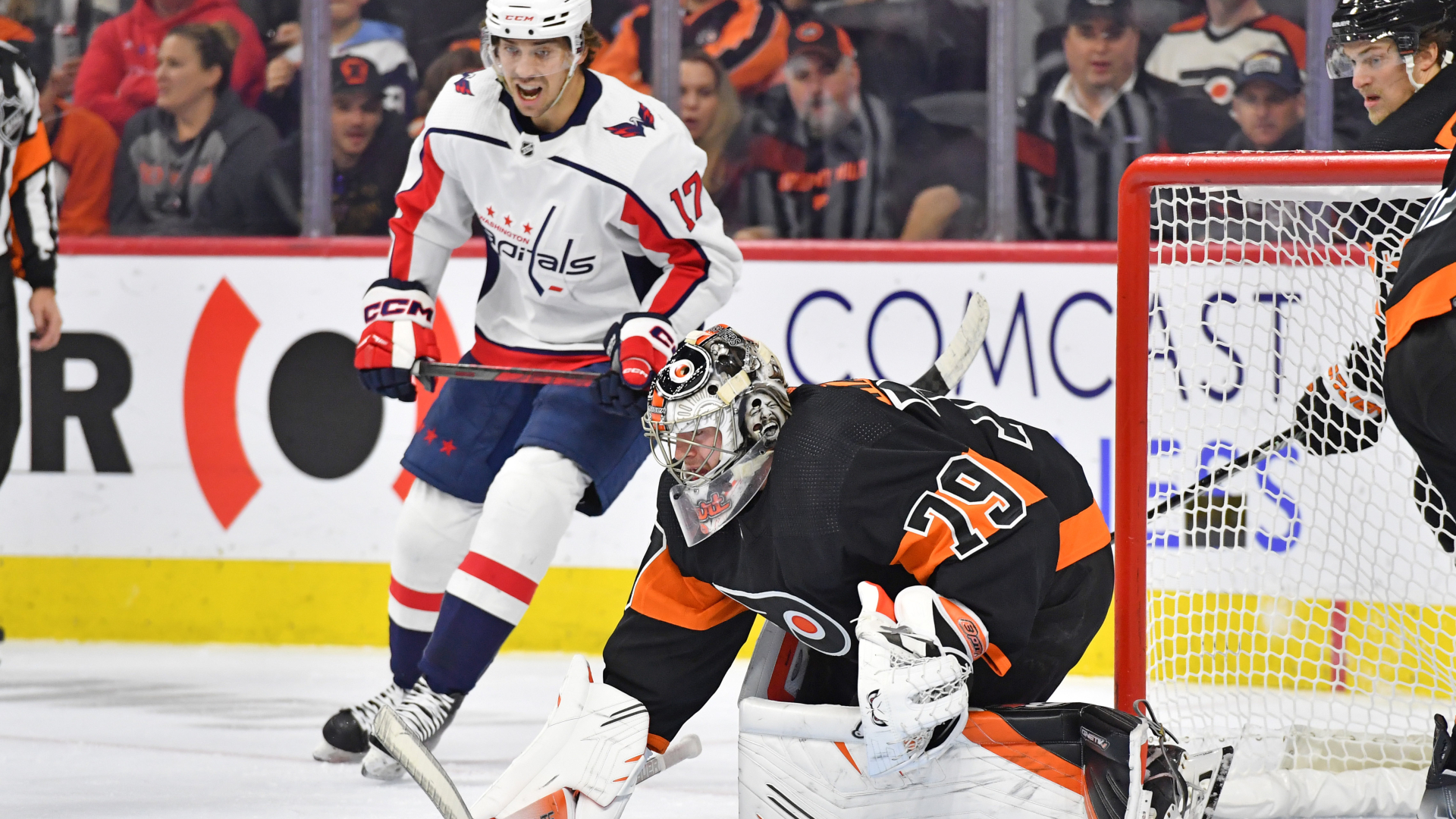 Flyers goaltender Carter Hart and Capitals center Dylan Strome eye the puck during the first period at Wells Fargo Center